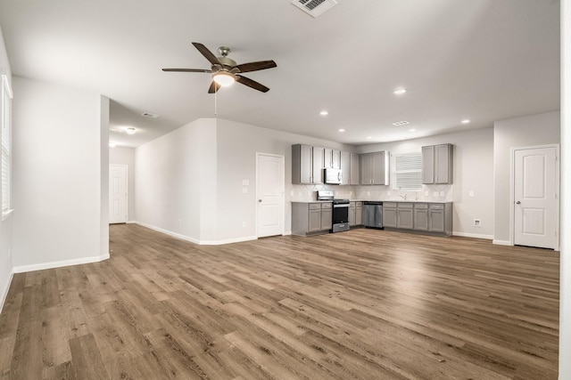 2580 Westslope Dr, Conroe, TX 77384 - unfurnished living room with ceiling fan, wood finished floors, and recessed lighting