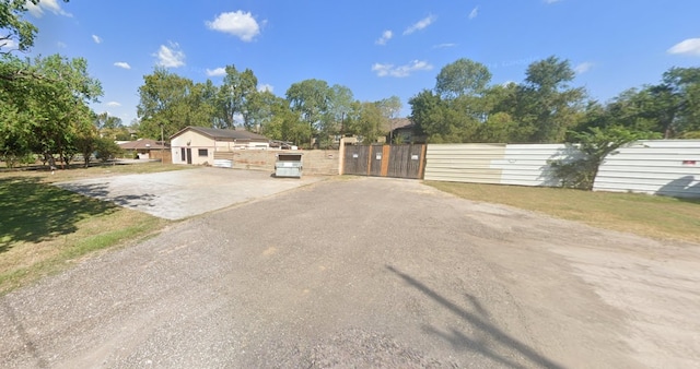 12418 Donna Dr, Houston, TX 77067 - view of asphalt driveway featuring a gate