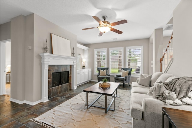 14427 Wickhurst Pl, Cypress, TX 77429 - living area featuring stairs, a ceiling fan, and a tile fireplace