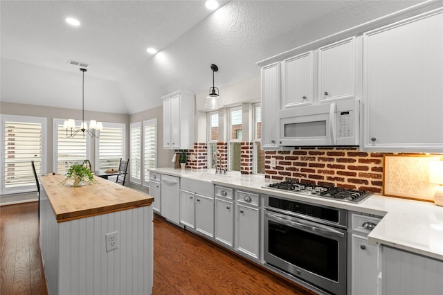14427 Wickhurst Pl, Cypress, TX 77429 - kitchen featuring stainless steel appliances, butcher block countertops, dark wood finished floors, a chandelier, and tasteful backsplash