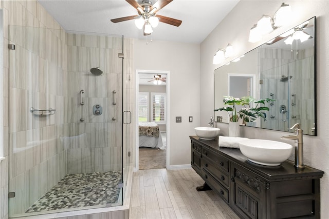 14427 Wickhurst Pl, Cypress, TX 77429 - bathroom featuring a ceiling fan, double vanity, and a stall shower