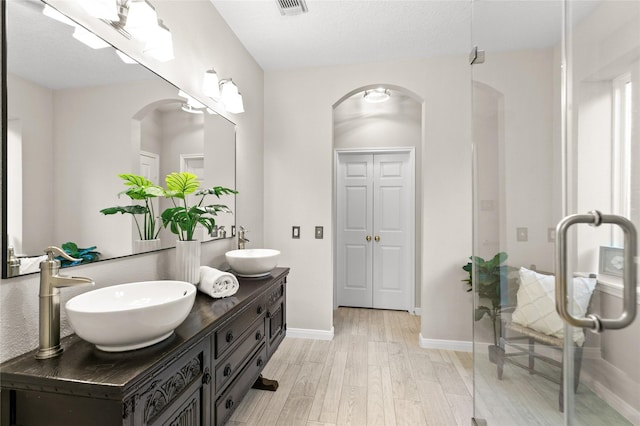 14427 Wickhurst Pl, Cypress, TX 77429 - bathroom featuring double vanity, wood finished floors, and a shower stall