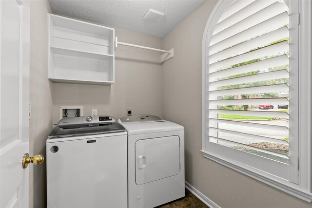 14427 Wickhurst Pl, Cypress, TX 77429 - washroom with washing machine and clothes dryer and a textured ceiling