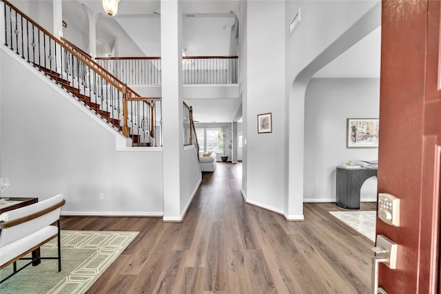 21142 Granite Trail Ln, Richmond, TX 77407 - foyer featuring wood finished floors, a high ceiling, stairway, and arched walkways
