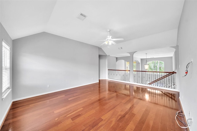 21142 Granite Trail Ln, Richmond, TX 77407 - empty room featuring vaulted ceiling, ceiling fan, wood finished floors, and a chandelier