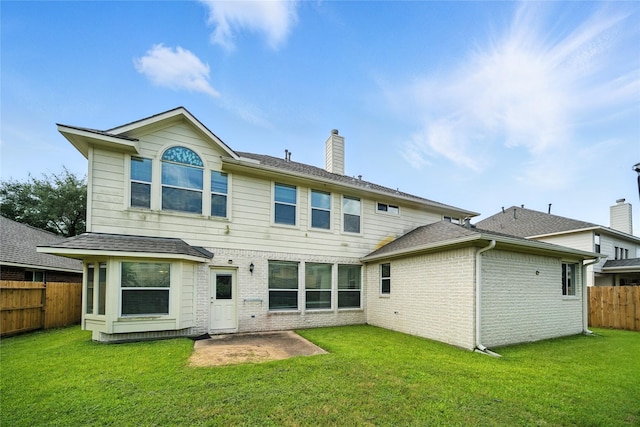 21142 Granite Trail Ln, Richmond, TX 77407 - back of property with a fenced backyard, a chimney, brick siding, a patio, and a shingled roof
