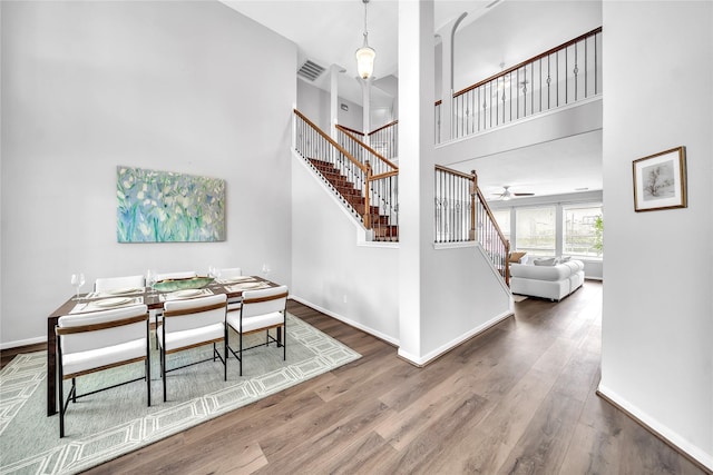 21142 Granite Trail Ln, Richmond, TX 77407 - dining area with stairs, wood finished floors, a towering ceiling, and ceiling fan