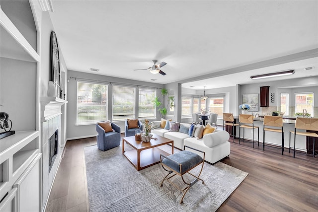 21142 Granite Trail Ln, Richmond, TX 77407 - living area with ceiling fan, a fireplace, and wood finished floors