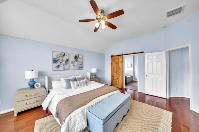 21142 Granite Trail Ln, Richmond, TX 77407 - bedroom with vaulted ceiling, wood finished floors, a barn door, and a ceiling fan