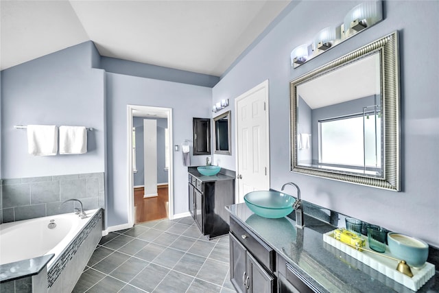 21142 Granite Trail Ln, Richmond, TX 77407 - full bath featuring two vanities, a bath, lofted ceiling, and tile patterned flooring