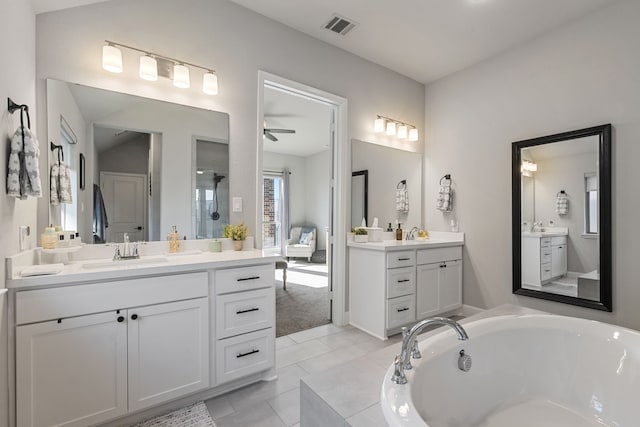 29726 Smoky Ridge Rd, Fulshear, TX 77441 - bathroom with two vanities, a bath, a ceiling fan, tile patterned floors, and a shower
