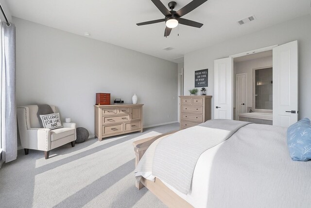 29726 Smoky Ridge Rd, Fulshear, TX 77441 - carpeted bedroom with connected bathroom and ceiling fan
