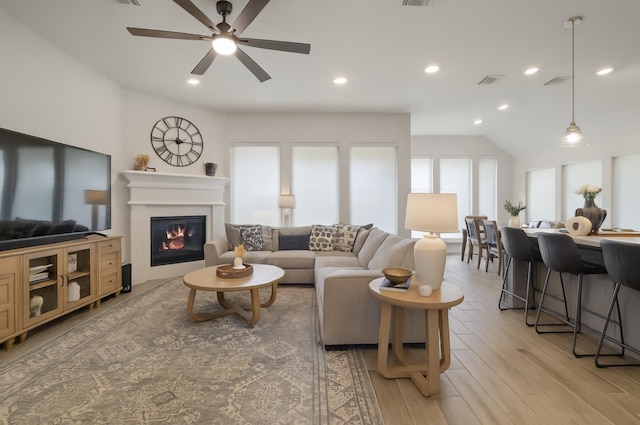 29726 Smoky Ridge Rd, Fulshear, TX 77441 - living room featuring a glass covered fireplace, light wood-style floors, ceiling fan, recessed lighting, and lofted ceiling