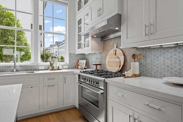 1217 Timbergrove Acres St, Houston, TX 77008 - kitchen with stainless steel range, under cabinet range hood, white cabinets, and healthy amount of natural light