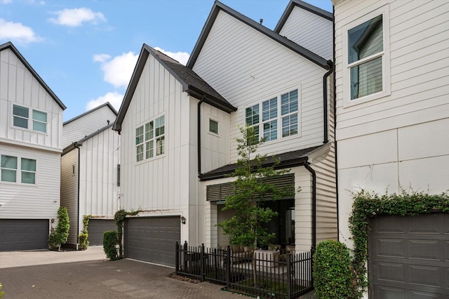 1217 Timbergrove Acres St, Houston, TX 77008 - view of front facade with board and batten siding, a garage, and decorative driveway