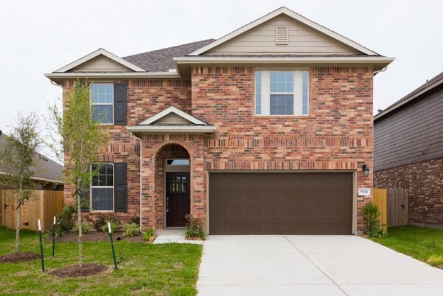 5018 Brewcastle Ln, Katy, TX 77493 - traditional-style house featuring an attached garage, brick siding, and driveway