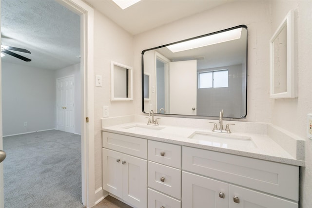 7911 Bova Rd, Houston, TX 77064 - full bath featuring double vanity, ceiling fan, and a textured ceiling