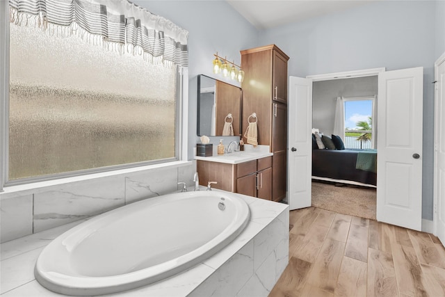 4802 Wagtail Way Ln, League City, TX 77573 - bathroom featuring a tub, vanity, connected bathroom, and wood finished floors