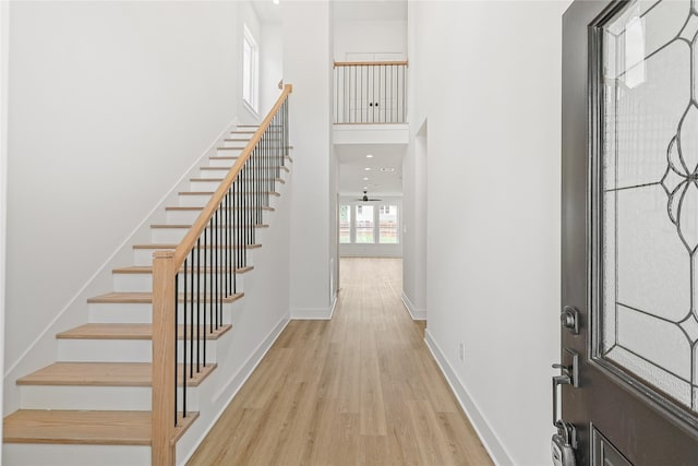 7411 Charlie St, Houston, TX 77088 - foyer featuring light wood finished floors, stairway, and a towering ceiling