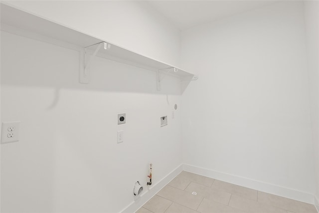 7411 Charlie St, Houston, TX 77088 - laundry area featuring hookup for a gas dryer, electric dryer hookup, washer hookup, and light tile patterned flooring