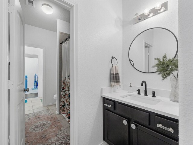 3327 Jane Way, Richmond, TX 77406 - bathroom featuring vanity, tile patterned flooring, a textured wall, and curtained shower