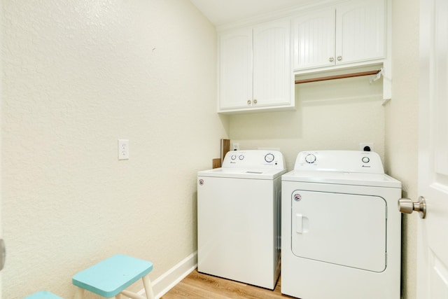 1214 Fort Velasco Dr, Surfside Beach, TX 77541 - laundry room with washing machine and clothes dryer, cabinet space, and light wood-type flooring