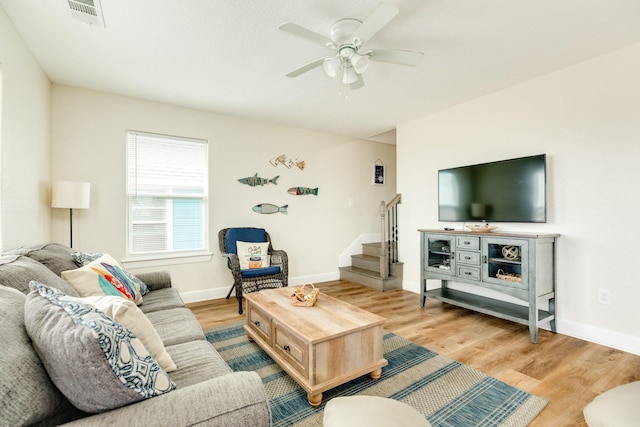 1214 Fort Velasco Dr, Surfside Beach, TX 77541 - living room with stairs, light wood-type flooring, and a ceiling fan