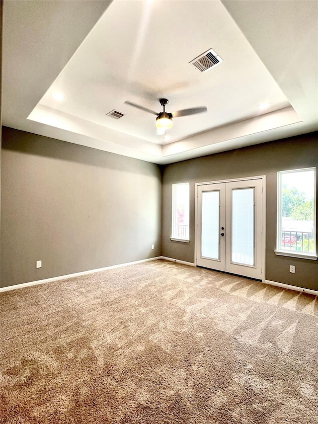 153 Treasure Dr, Houston, TX 77076 - carpeted empty room featuring a tray ceiling, ceiling fan, and french doors