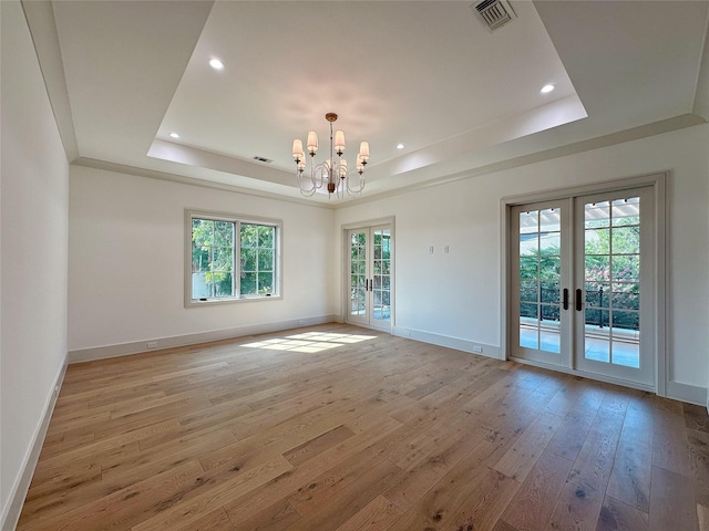3818 Drake St, Houston, TX 77005 - spare room featuring a raised ceiling, french doors, light wood-style floors, a chandelier, and recessed lighting