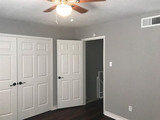 5625 Antoine Dr Unit 903, Houston, TX 77091 - unfurnished bedroom with dark wood finished floors, a closet, and a ceiling fan