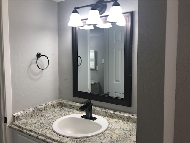 5625 Antoine Dr Unit 903, Houston, TX 77091 - bathroom with vanity, a textured wall, and a chandelier