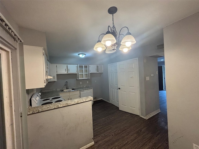 5625 Antoine Dr Unit 903, Houston, TX 77091 - kitchen featuring white appliances, a chandelier, white cabinets, dark wood-type flooring, and a peninsula