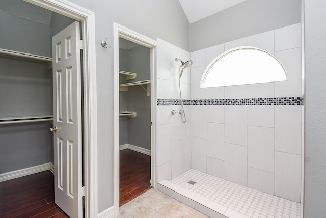 4706 Torrington Ct, Sugar Land, TX 77479 - bathroom featuring a shower stall, lofted ceiling, a spacious closet, and wood finished floors