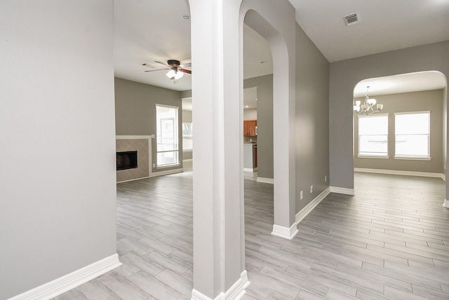 4706 Torrington Ct, Sugar Land, TX 77479 - corridor featuring arched walkways, light wood finished floors, and a chandelier