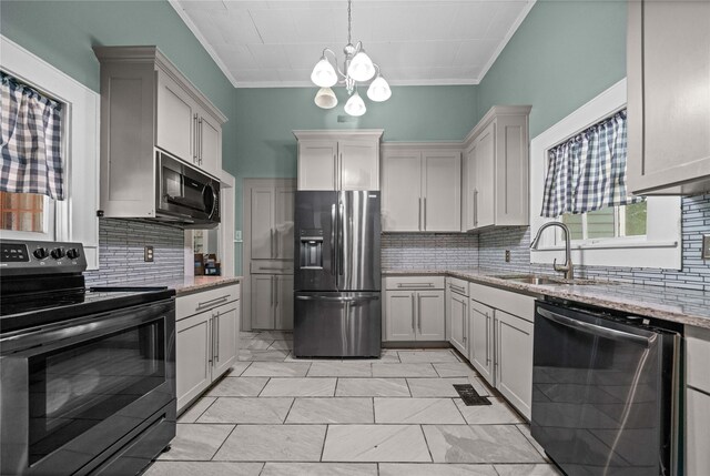 246 W 6th St, Rusk, TX 75785 - kitchen featuring stainless steel appliances, crown molding, backsplash, light stone countertops, and a chandelier