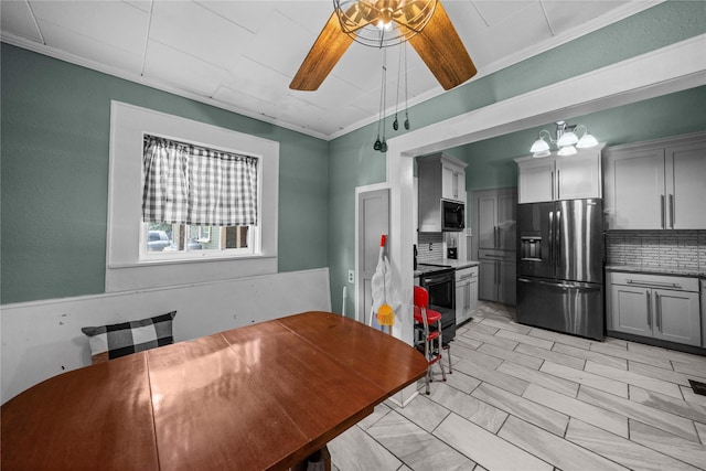 246 W 6th St, Rusk, TX 75785 - dining space featuring ornamental molding, a chandelier, and a ceiling fan