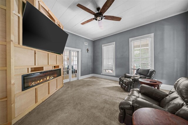 246 W 6th St, Rusk, TX 75785 - living room with carpet, a ceiling fan, a glass covered fireplace, and crown molding