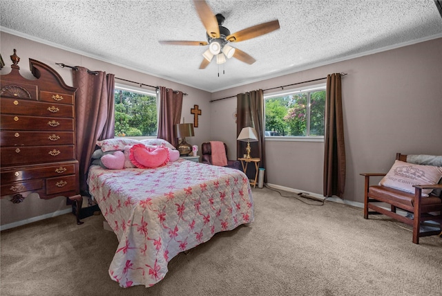 246 W 6th St, Rusk, TX 75785 - carpeted bedroom featuring ornamental molding, a textured ceiling, and a ceiling fan