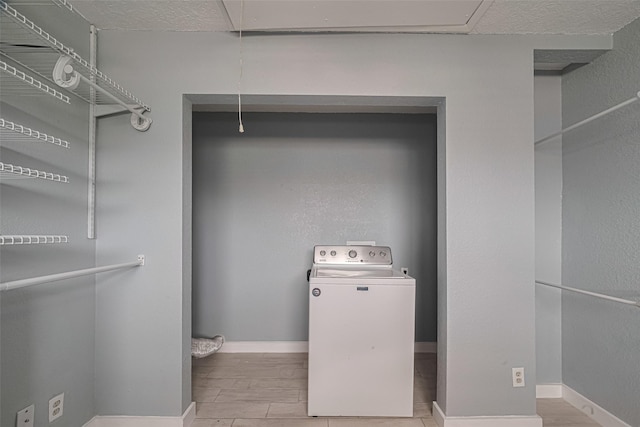228 Barracuda St, Bayou Vista, TX 77563 - laundry room featuring washer / clothes dryer and wood finished floors