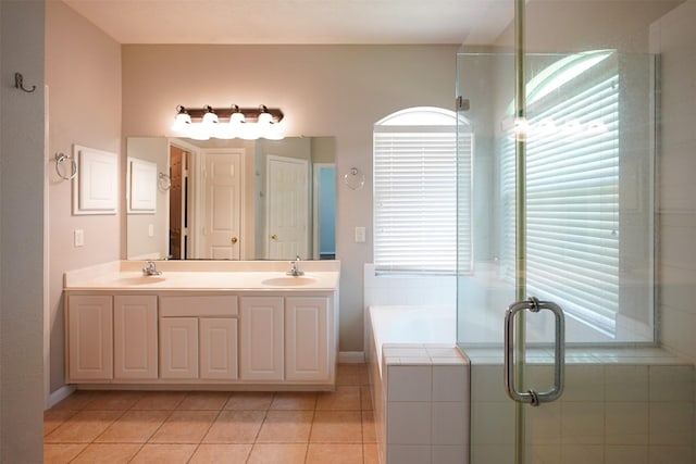 105 N Hollylaurel Cir, The Woodlands, TX 77382 - full bath with tile patterned floors, double vanity, a garden tub, and a stall shower