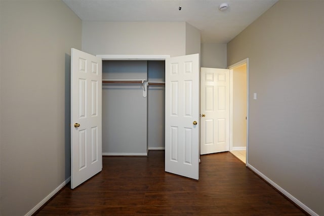 105 N Hollylaurel Cir, The Woodlands, TX 77382 - unfurnished bedroom featuring dark wood-type flooring and a closet