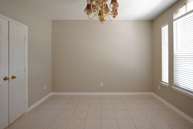 105 N Hollylaurel Cir, The Woodlands, TX 77382 - empty room featuring a chandelier and light tile patterned floors