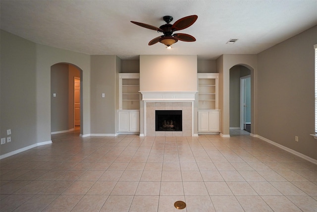 105 N Hollylaurel Cir, The Woodlands, TX 77382 - unfurnished living room with ceiling fan, arched walkways, and light tile patterned floors
