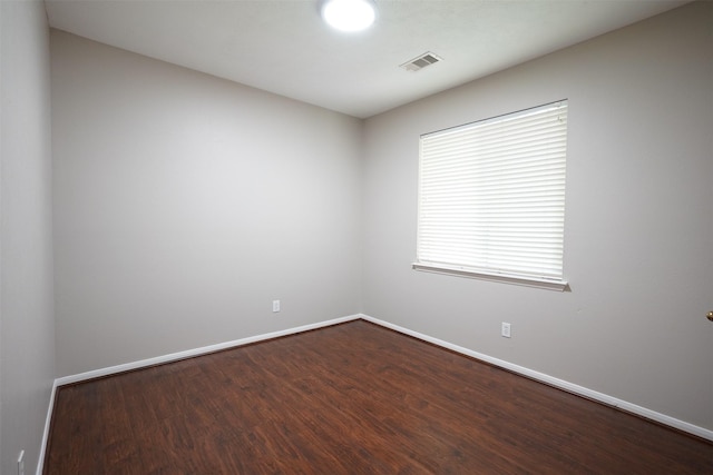 105 N Hollylaurel Cir, The Woodlands, TX 77382 - unfurnished room with baseboards and dark wood-style floors