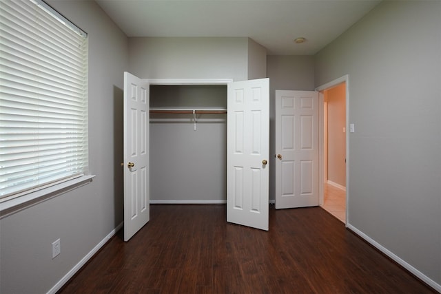 105 N Hollylaurel Cir, The Woodlands, TX 77382 - unfurnished bedroom with wood finished floors and a closet