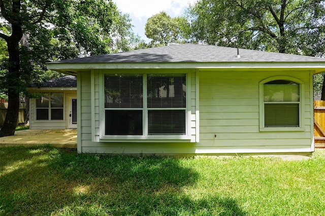 105 N Hollylaurel Cir, The Woodlands, TX 77382 - view of property exterior featuring a shingled roof and a patio