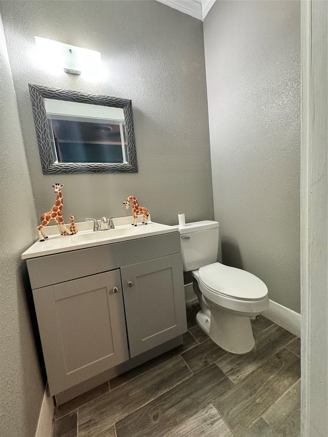 918 E Mcalpine St, Navasota, TX 77868 - bathroom featuring vanity, wood finished floors, ornamental molding, and a textured wall