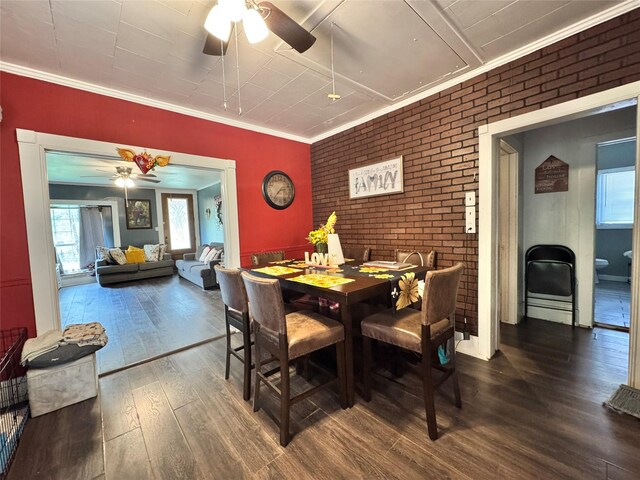 918 E Mcalpine St, Navasota, TX 77868 - dining room featuring a ceiling fan, wood finished floors, brick wall, and ornamental molding