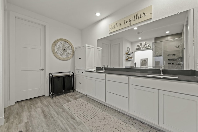10009 Gray Jay Ct, Conroe, TX 77384 - full bath featuring a shower stall, double vanity, wood finished floors, and recessed lighting