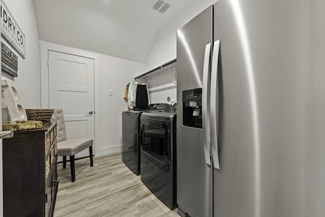 10009 Gray Jay Ct, Conroe, TX 77384 - washroom with washer and clothes dryer and light wood-style floors